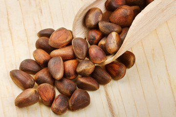 Wooden scoop with pine nuts