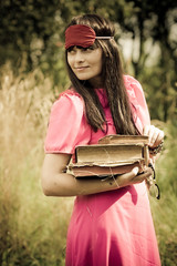 Woman in pink holding old books