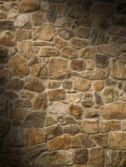 Masonry rock wall lit diagonally