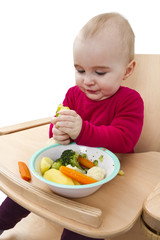 young child eating in high chair