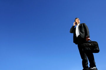 Businessman talking on his mobile phone on a sunny day