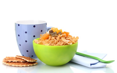tasty cornflakes in green bowl and glass of milk isolated
