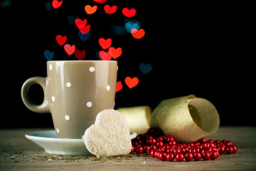 cup of coffee on wooden table on bright bokeh backdground