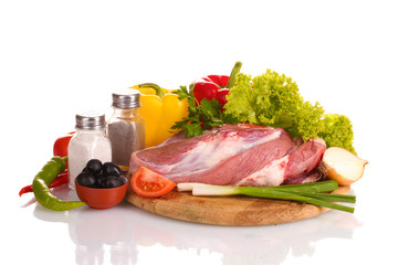 Raw meat and vegetables on a wooden board isolated on whitе