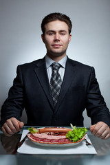 Young businessman eating