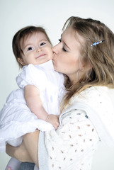 The small beautiful girl at mum on hands on a white background