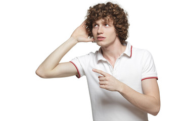 Man listening with hand on ear and pointing sideways