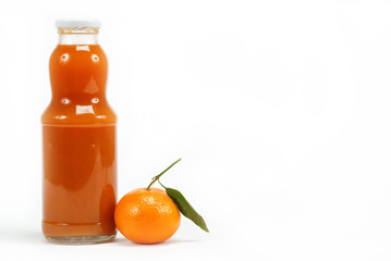 Juice in a glass bottle and tropical fruit on a white background