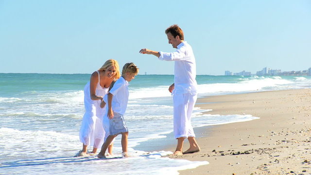 Caucasian Family Group Enjoying Beach Lifestyle