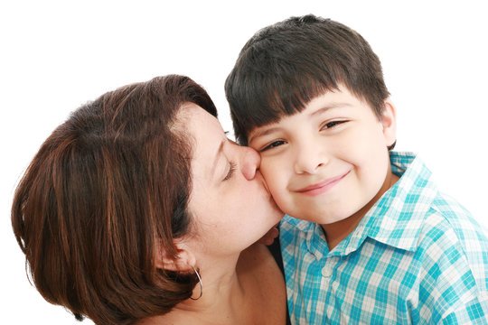 Adorable mother kissing her beautiful son isolated on white back