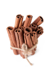 Close-up of cinnamon sticks, isolated over white