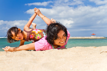 Asian mother and child fun play at the beach