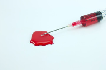syringe with blood isolated on white