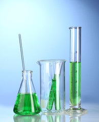 Laboratory glassware with green liquid with reflection