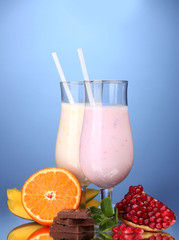 Milk shakes with fruits and chocolate on blue background