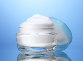 cosmetic cream on blue background
