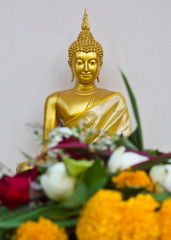 Altar flowers with golden statues.