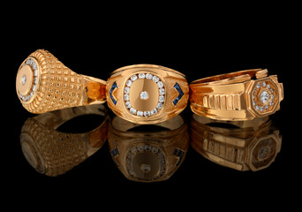 Golden rings with diamonds on black © dimj