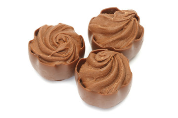 Chocolate pralines on white background