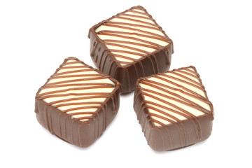 Chocolate pralines on white background