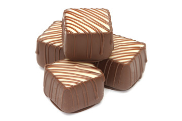 Chocolate pralines on white background