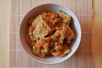 Stew tempeh with carrots, leeks and soy sauce in a bowl