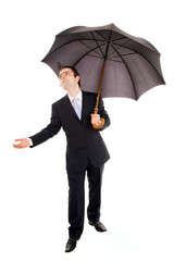 Full lenght of young business man with umbrella and checking the