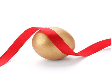 A golden egg with red tape  isolated on white