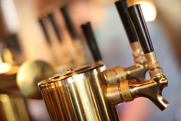 Row of beer taps in a tavern.