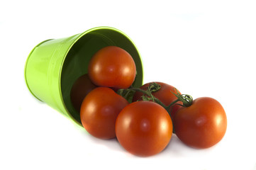 green container with red tomatoes