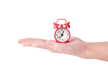 small red clock on a hand