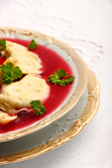 Delicious dumplings with champignon mushrooms stuffing in borsch
