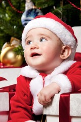 Little Santa boy with gift boxes.