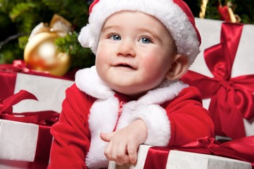 Little Santa boy with gift boxes.