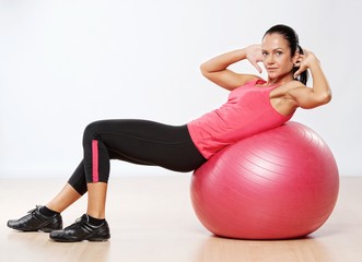 Fototapeta premium Beautiful athlete woman with a fitness ball.