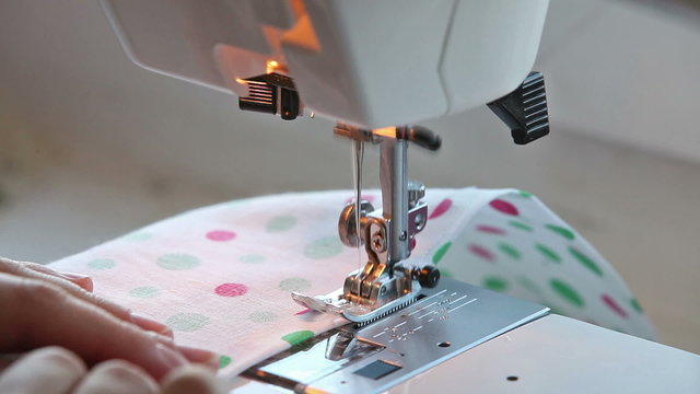Closeup view of girl sewing on machine