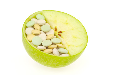 Close up of apple and pills isolated - vitamin concept