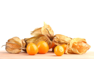 Physalis heap on wooden table on white background