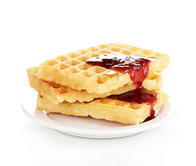 Tasty waffles with jam on plate isolated on white