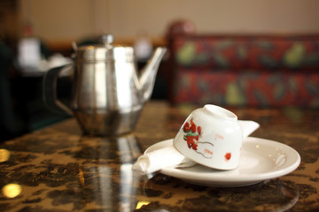 Tea pot and cup in a Chinese restaurant.