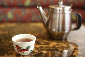 Tea pot and cup in a Chinese restaurant.