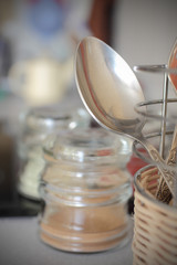 cupronickel spoon on background of domestic utensils