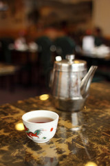 Tea pot and cup in a Chinese restaurant.