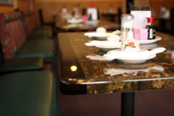 Set places at tables inside a Chinese restaurant.