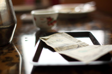 Cash tip on table at a Chinese restaurant.