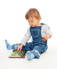 Young kid playing with tablet pc