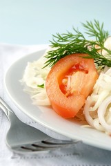 salad of tomato, cabbage and onions garnished with greenery