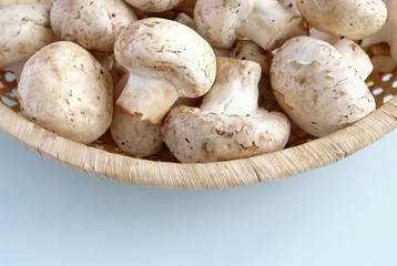 raw mushrooms in a wicker bowl on the table