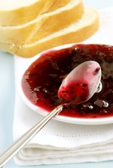 red jam on the plate and the bread on the table