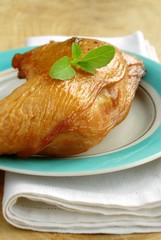 smoked gammon of chicken in a plate and a basil